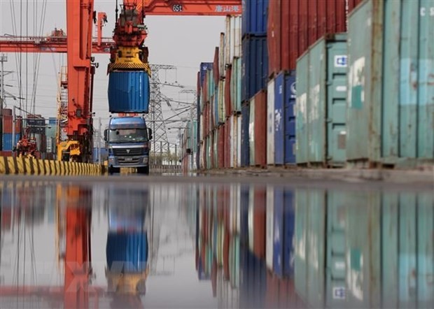 Unloading container cargo at a port, illustrating logistics and freight transport processes