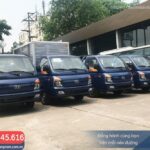 Hình ảnh xe tải Hyundai Porter H150 màu trắng đang đậu trong showroom, phía sau là logo Hyundai Thành Công