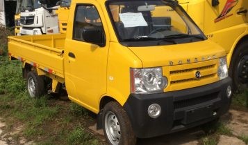 Dongben 870kg truck with a flatbed, side view