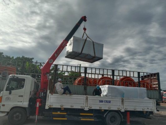 Crane truck unloading a container