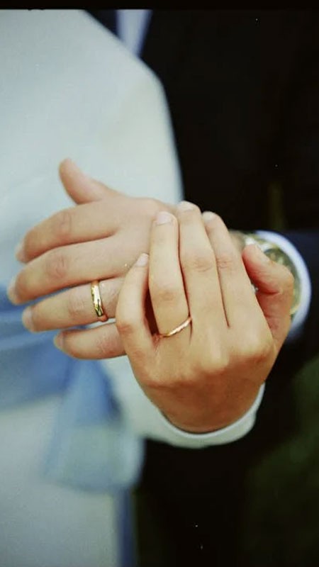 Cặp đôi nắm tay nhau trước một địa danh nổi tiếng, thể hiện sự đồng hành và khám phá.