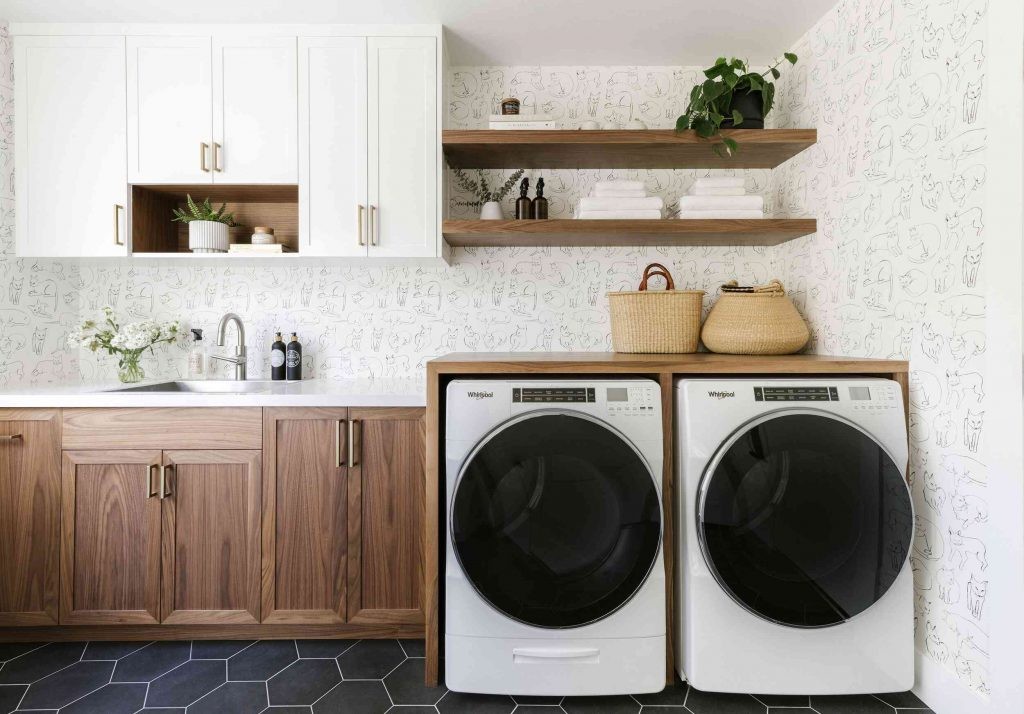 Phòng giặt với máy giặt và máy sấy, và bồn rửa có vòi nước.