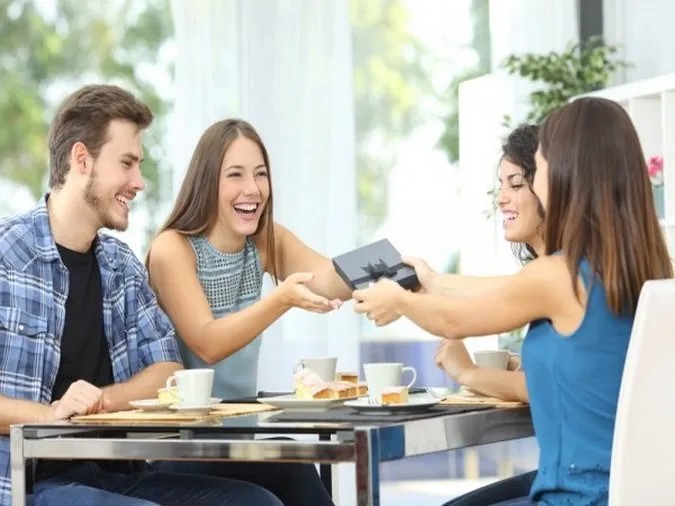 Hình ảnh nhóm bạn vui vẻ ăn uống cùng nhau, thể hiện sự hào phóng và chia sẻ