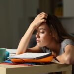Cô gái mệt mỏi đang cố gắng hoàn thành bài tập về nhà