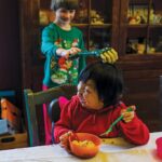 Vincent teases his sister Mei Ting, 6, with a toy claw. Photo by Allison Mah